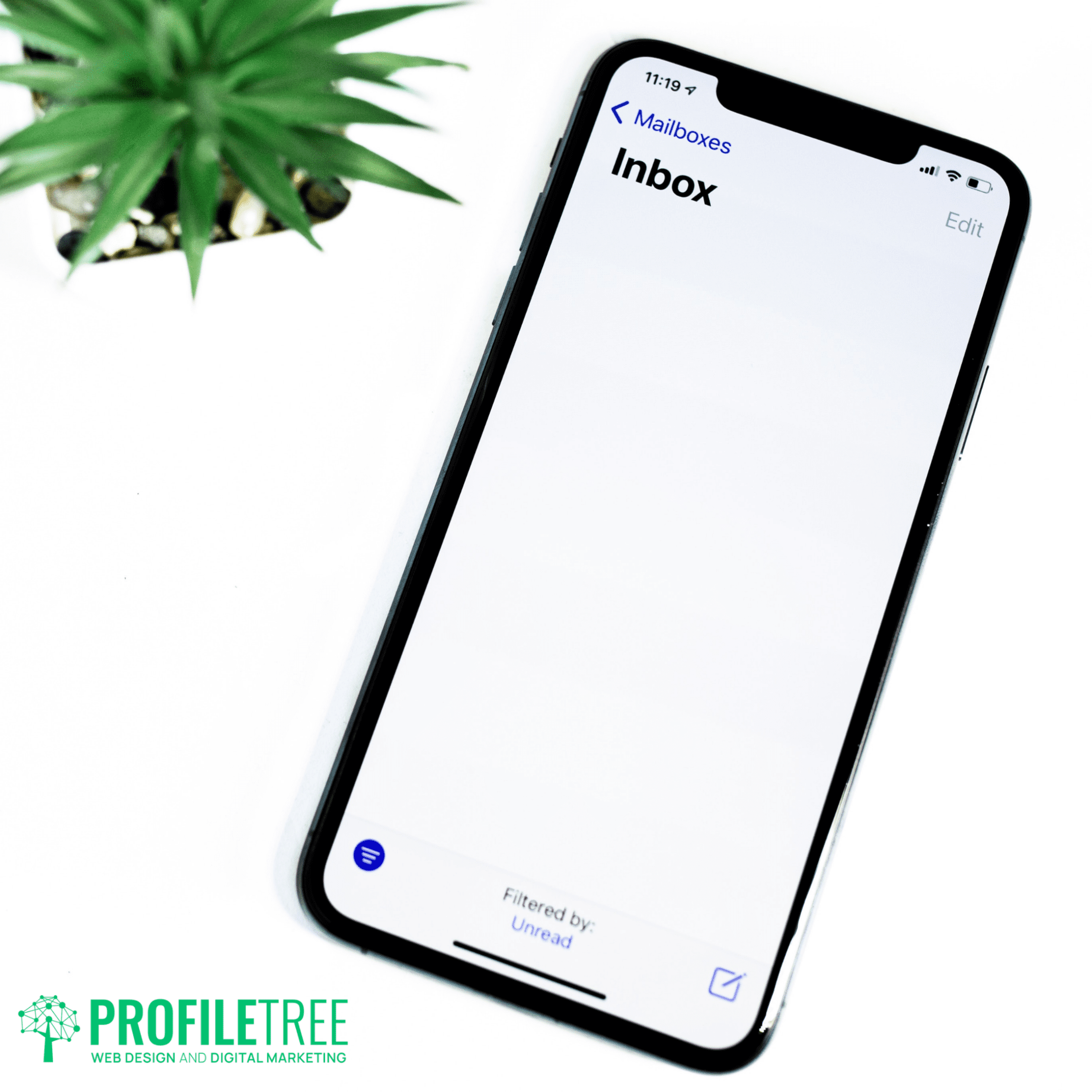 A smartphone displaying an empty email inbox screen is placed on a white surface next to a green potted plant. The ProfileTree logo is visible in the bottom left corner.